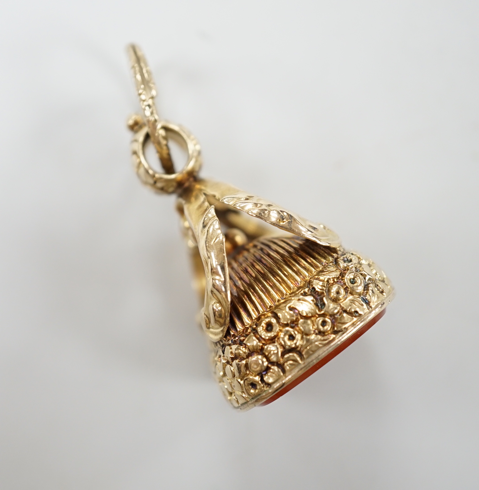 A 19th century yellow metal overlaid and carnelian set fob seal, the matrix carved with crest and monogram, 37mm.